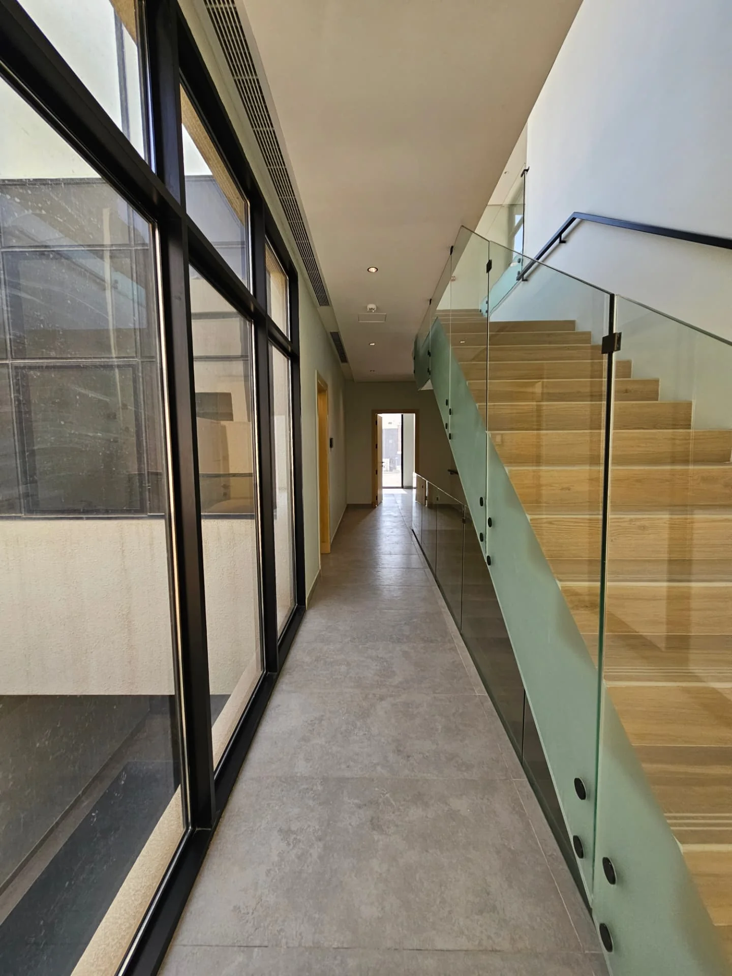 Villa for sale in Al Nayfa Compound, Al Munsiyah, Riyadh – glass-walled hallway