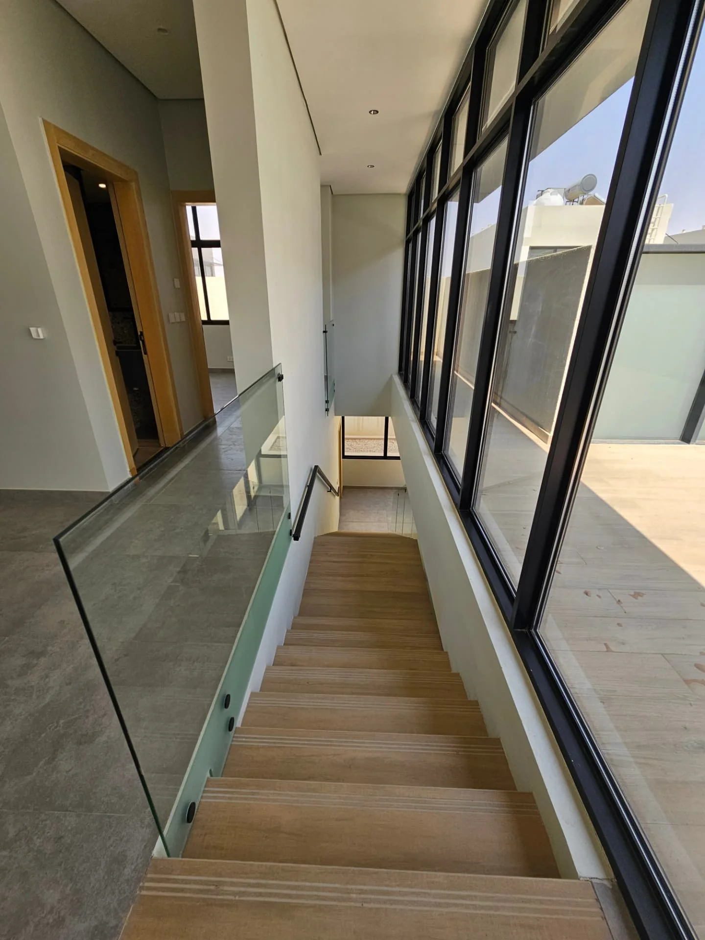 Villa for sale in Al Nayfa Compound, Al Munsiyah, Riyadh – staircase with glass balustrade
